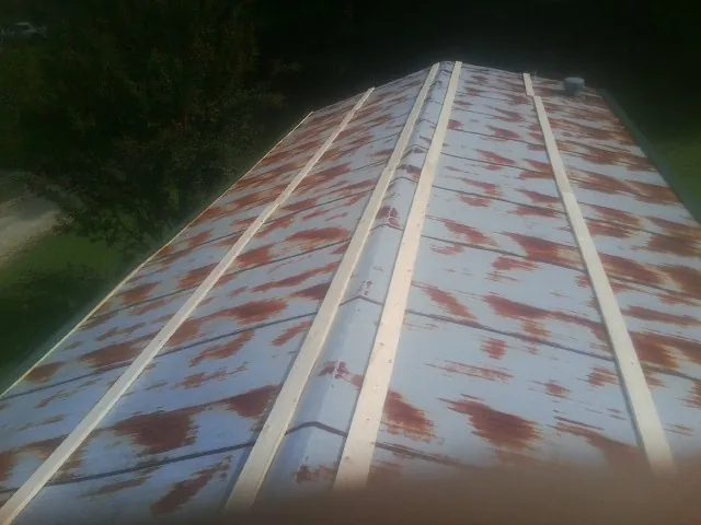 Rusted metal roof panels with new wood purlins before replacement — Storm Damage Roof Repair in Armona by Roofing Brothers